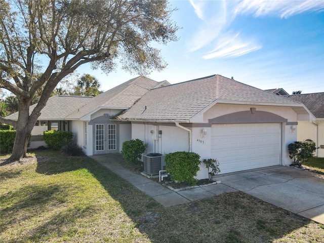 ranch-style home featuring a shingled roof, a front lawn, stucco siding, french doors, and an attached garage