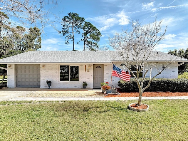 single story home with brick siding, a shingled roof, a garage, driveway, and a front lawn