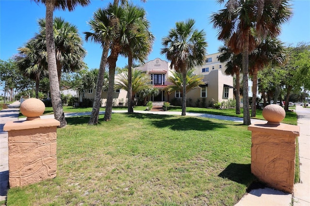 view of property's community with a yard