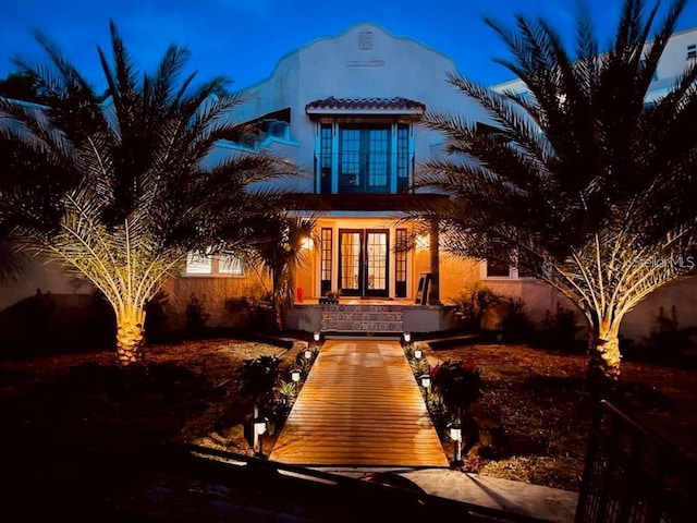 view of front of home featuring french doors and stucco siding