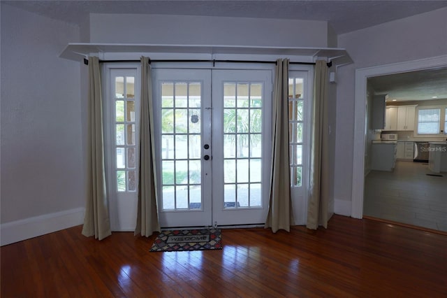 entryway with hardwood / wood-style flooring, french doors, and baseboards