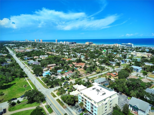 birds eye view of property with a water view and a city view