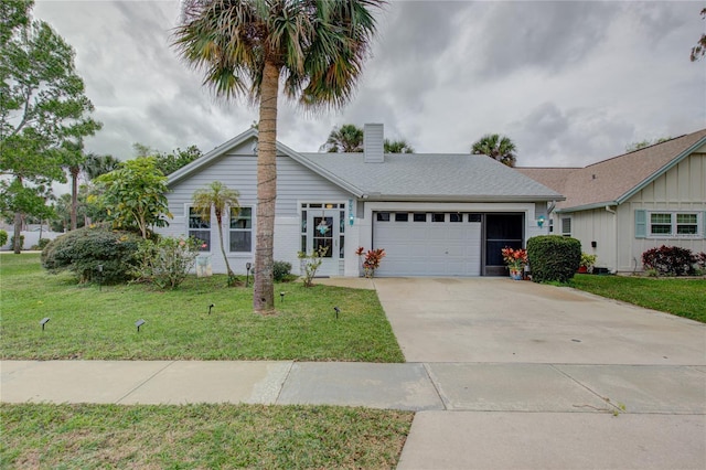 ranch-style home with an attached garage, driveway, roof with shingles, a chimney, and a front yard