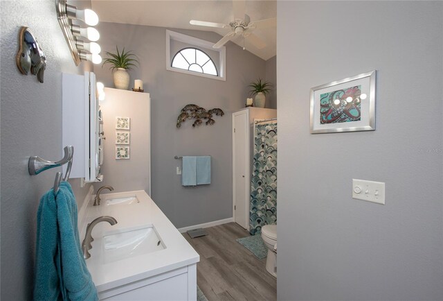 full bathroom with lofted ceiling, a sink, toilet, and wood finished floors