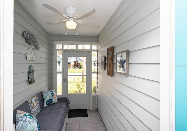 doorway to outside with a healthy amount of sunlight, ceiling fan, and light tile patterned floors