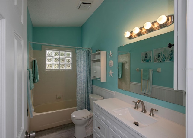 bathroom featuring toilet, wainscoting, vanity, and visible vents