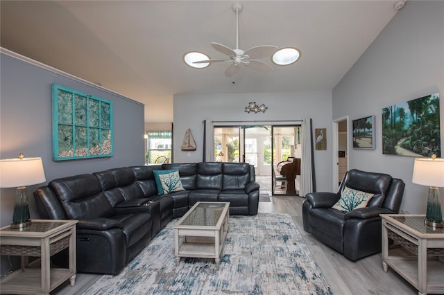 living area featuring lofted ceiling, ceiling fan, and wood finished floors