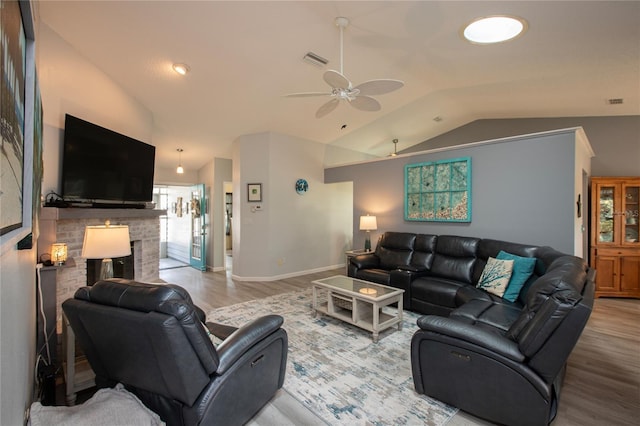 living room featuring lofted ceiling, wood finished floors, and visible vents