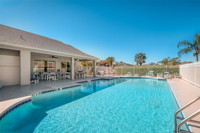 pool with ceiling fan, a patio, and fence