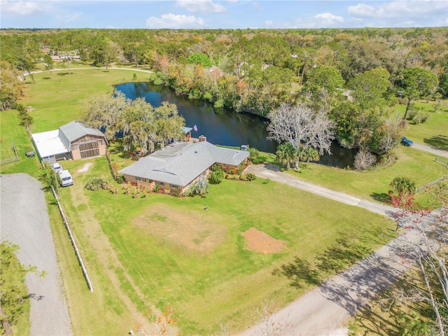 drone / aerial view featuring a water view and a view of trees