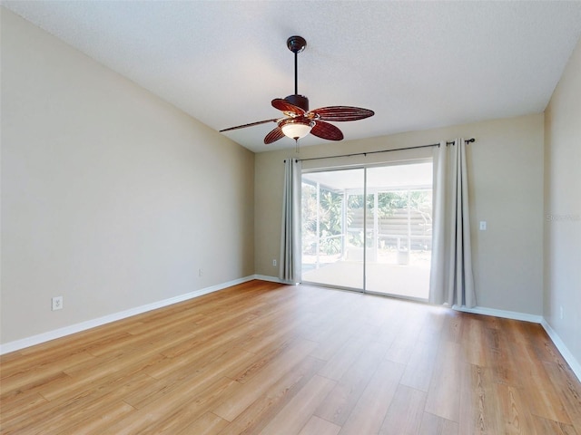 spare room with a ceiling fan, baseboards, and light wood finished floors