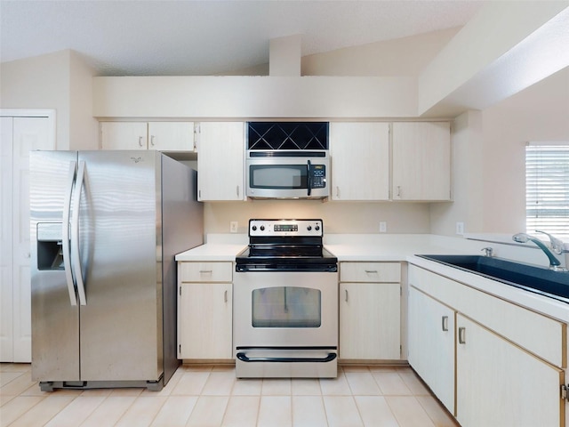 kitchen with stainless steel appliances, light countertops, and a sink
