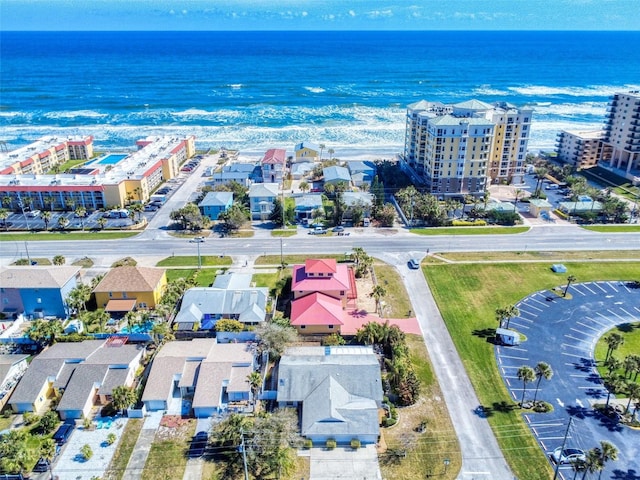 drone / aerial view featuring a view of city and a water view