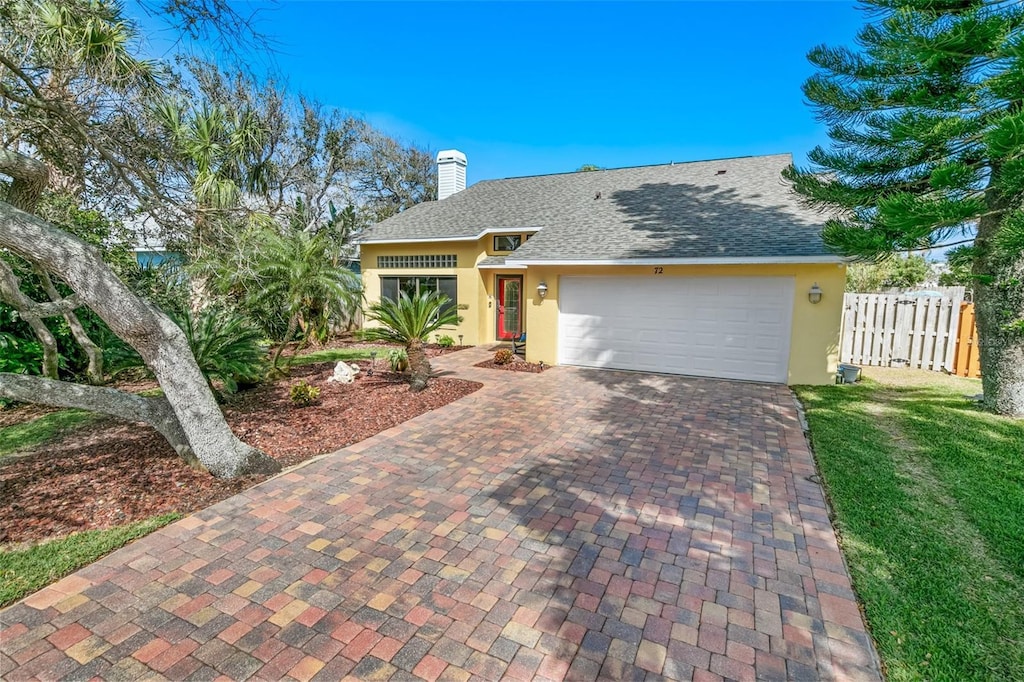 72 Oceanview Ave, Ponce Inlet, FL 32127 - single story home with decorative driveway, an attached garage, fence, and stucco siding