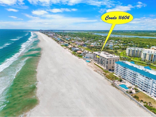 birds eye view of property with a beach view and a water view