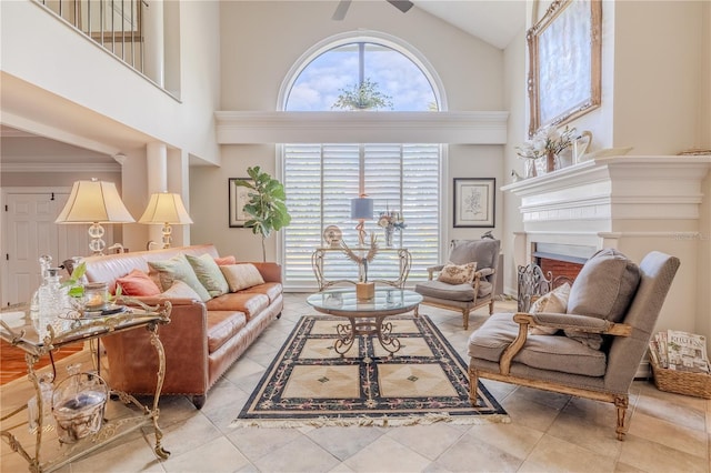 tiled living area with a high ceiling and a healthy amount of sunlight