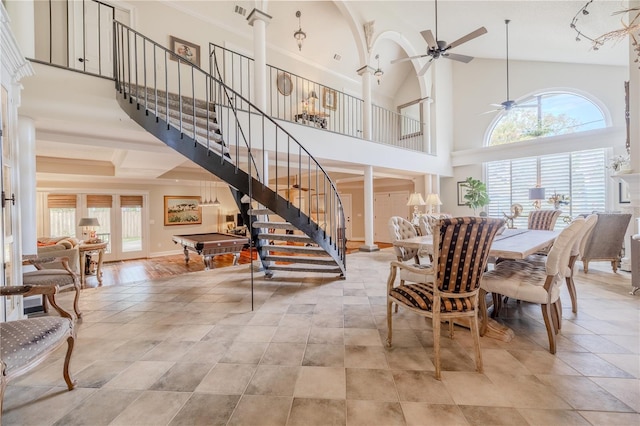 dining space with a ceiling fan, decorative columns, stairway, and a wealth of natural light