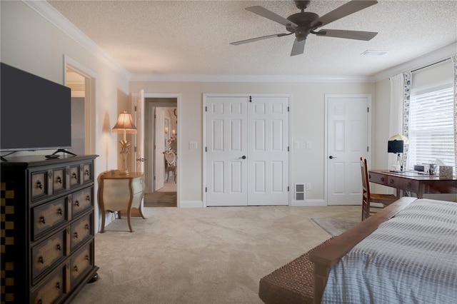 bedroom with light carpet, crown molding, and a textured ceiling