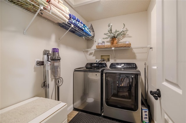 laundry area featuring laundry area, baseboards, and separate washer and dryer