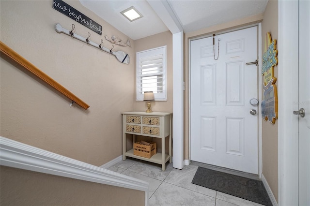111 N Atlantic Ave Unit A219, New Smyrna Beach, FL 32169 - foyer entrance with baseboards and light tile patterned floors