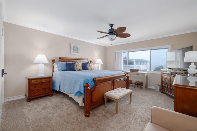 111 N Atlantic Ave Unit A219, New Smyrna Beach, FL 32169 - bedroom featuring a ceiling fan, baseboards, light colored carpet, and crown molding