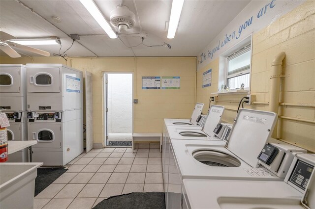 111 N Atlantic Ave Unit A219, New Smyrna Beach, FL 32169 - common laundry area featuring ceiling fan, washer and dryer, stacked washer / drying machine, and light tile patterned floors