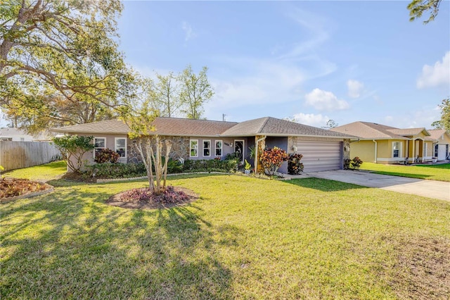 single story home with a garage, a front yard, driveway, and fence