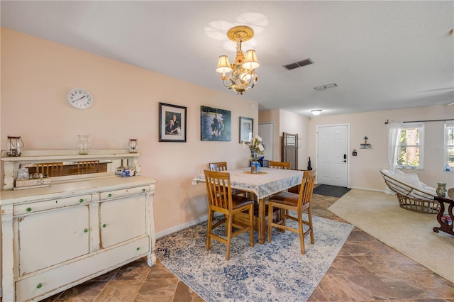 dining area with visible vents, baseboards, and a notable chandelier