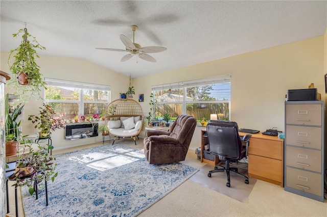 office featuring light carpet, vaulted ceiling, a textured ceiling, and ceiling fan