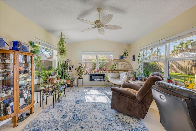 living room featuring vaulted ceiling, ceiling fan, carpet floors, and plenty of natural light