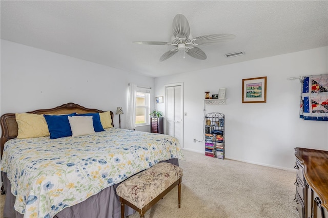 bedroom with a closet, carpet, visible vents, and baseboards