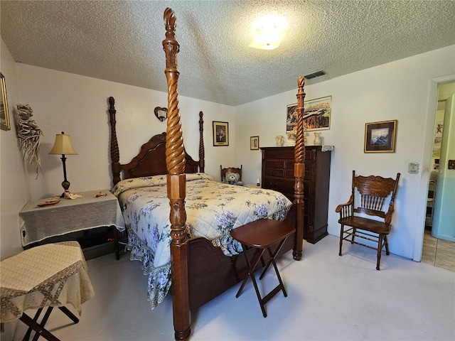 bedroom with visible vents and a textured ceiling