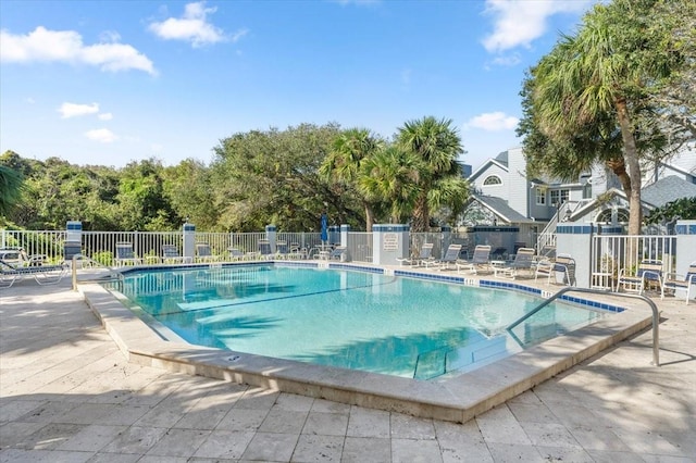 community pool featuring a patio area and fence