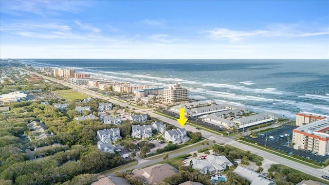 birds eye view of property featuring a water view and a city view