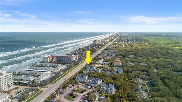 drone / aerial view featuring a water view and a view of the beach