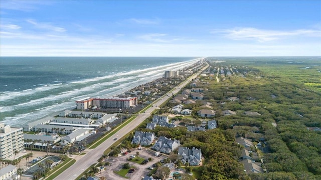 bird's eye view with a water view and a beach view