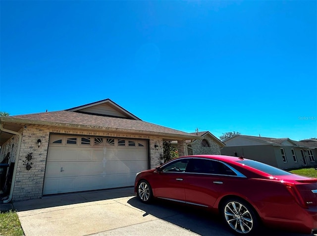 single story home featuring an attached garage, driveway, and a shingled roof