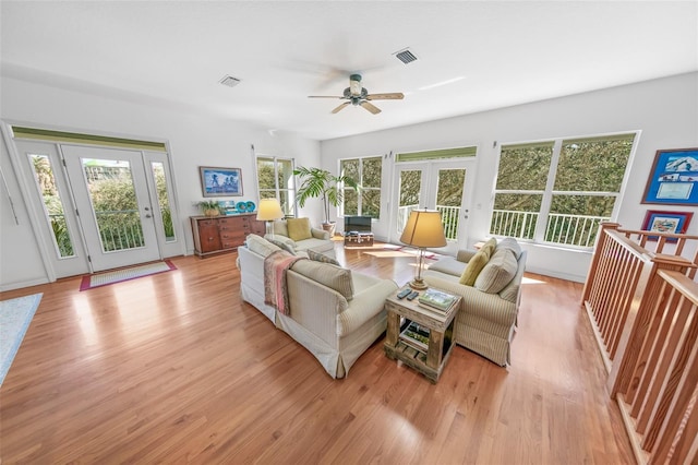 sunroom featuring ceiling fan, visible vents, and french doors