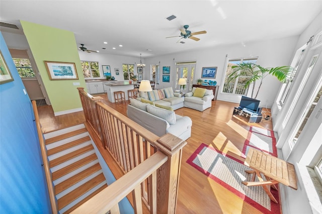 living area featuring recessed lighting, visible vents, a notable chandelier, and light wood finished floors