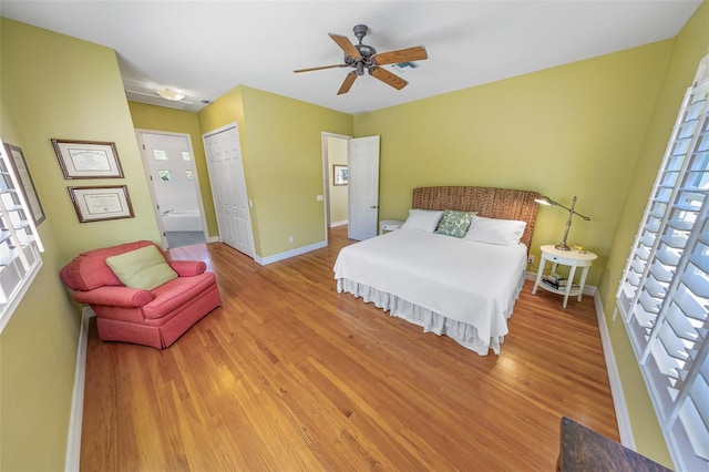 bedroom featuring baseboards, ceiling fan, a closet, and light wood-style floors