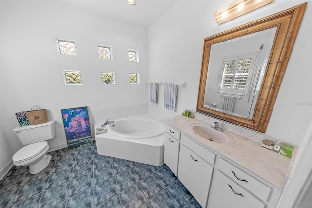 bathroom featuring baseboards, toilet, tile patterned floors, vanity, and a bath