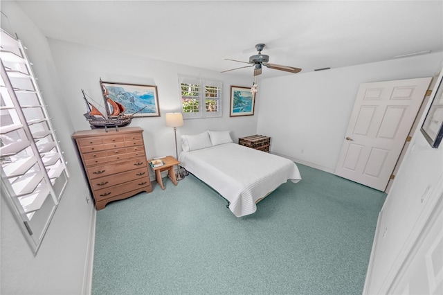 carpeted bedroom with a ceiling fan and visible vents