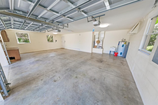 garage with a garage door opener and water heater