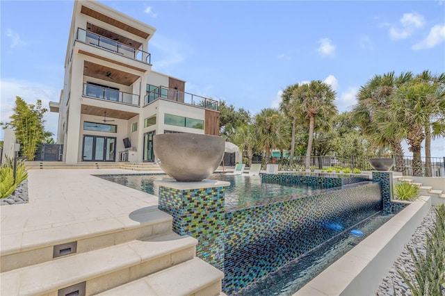 view of swimming pool with french doors, a patio area, fence, and ceiling fan