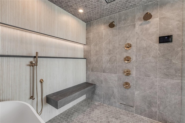 interior details with a soaking tub and a tile shower