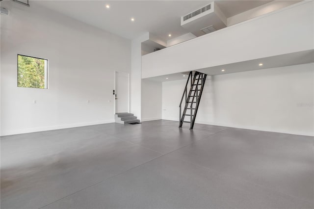 garage featuring baseboards, visible vents, and recessed lighting