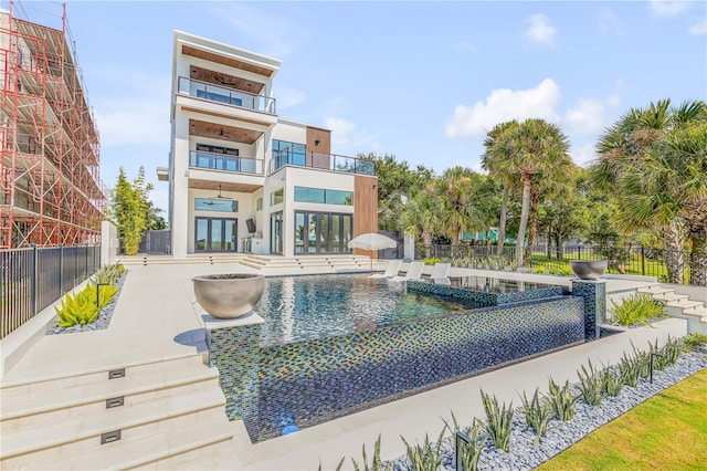 view of swimming pool with fence and a patio