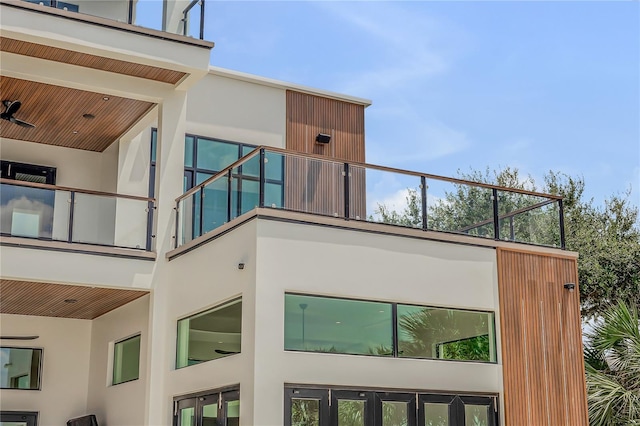 view of property exterior with stucco siding and a balcony
