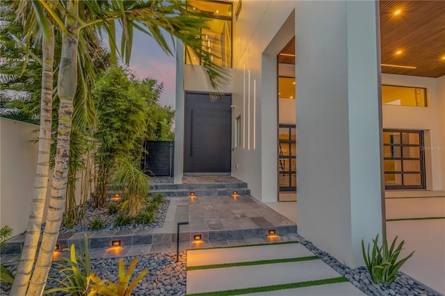 property entrance with stucco siding