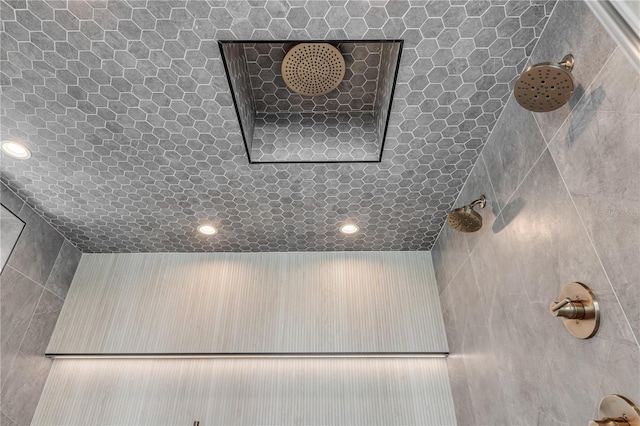 bathroom view of tiled shower and recessed lighting